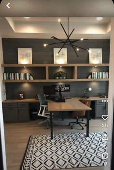 a home office with built in shelving units