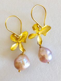 "Champagne pink Chinese freshwater Kasumi pearl earrings wire wrapped on handmade gold vermeil blossoms with 24k Gold vermeil French hooks. Beautiful 11/12mm Chinese Kasumi pearls with characteristic iridescent bumpy surface are full of color and texture and highly lustrous. Stunning Kasumi pearls are wire wrapped on artisan 22k gold vermeil blossom. Precious metal blossom elements are made of 22k gold over solid Sterling silver. Handmade and hand brushed one at a time they measure 18 x 16mm Ear Handmade Gold Pearl Earrings In Flower Shape, Gold Petal Earrings For Gift, Handmade Gold Petal-shaped Jewelry, Cherry Blossom Earrings, Champagne Pink, Earrings Wire, Aquamarine Earrings, Baroque Pearl Earrings, Pink Orchids