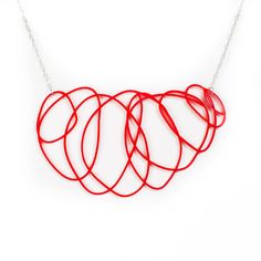 People are def going to notice your stunning sense of style when wearing this delicate red statement necklace. The red calligraphic lines turn this necklace into a work of art that you can wear. Show off your creative sense of style and be happy wearing an unique accessory. DETAILS This delicate red statement necklace is made from laser-cut red acrylic. It's safe, durable and lightweight. The red pendant itself is about 5 inches long; the chain is 14 inches long. The necklace usually lies below Modern Red Necklace Perfect As A Gift, Modern Red Necklace For Party, Modern Red Necklace For Gift, Minimalist Red Pendant Necklace, Red Minimalist Pendant Necklace, Cheap Red Statement Necklaces, Modern Red Adjustable Necklace, Playful Red Adjustable Necklace, Luxury Red Statement Necklaces