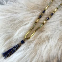 Beautiful Shades Of Blue, Yellow, Cream And Brass Beads With Multiple Silver Strands Can Be Worn 3 Different Ways! Wear It With Or Without The Blue Beaded Tassel At The Bottom Or Spin It Around So The Silver Strands Are At The Bottom. A Gorgeous Piece With Lots Of Different Looks! Measures At A 16” Drop Without The Tassel Which Measures 3”. Display Only. Never Worn. Excellent Condition. Blue Beaded Tassel Long Necklace, Blue Beaded Long Tassel Necklace, Blue Tassel Necklace For The Beach, Blue Beaded Tassel Necklace, Blue Beaded Tassel Necklace For Festival, Yellow Bohemian Necklace With Faceted Beads, Blue Bohemian Beaded Necklaces With Tassels, Adjustable Blue Tassel Necklace For Festivals, Bohemian Blue Beaded Necklaces With Tassels