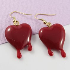 Cute'n'Kitsch Earrings with 3D Bleeding Heart Charms      Great Halloween Accessory!       Materials:     Earring Hooks - Brass   Charms - Resin      Approx. Total Earring Length:  45mm Novelty Heart-shaped Earrings For Gift, Red Heart-shaped Novelty Jewelry, Handmade Heart-shaped Novelty Earrings, Valentine's Day Novelty Dangle Earrings, Valentine's Day Novelty Dangle Jewelry, Valentine's Day Heart-shaped Novelty Earrings, Handmade Novelty Earrings For Valentine's Day, Novelty Earrings For Valentine's Day Party, Novelty Earrings For Party On Valentine's Day