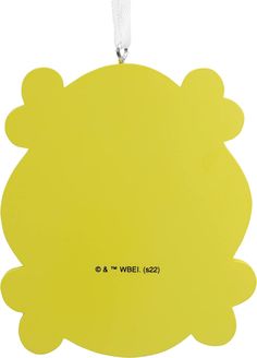 a yellow ornament hanging from a white cord