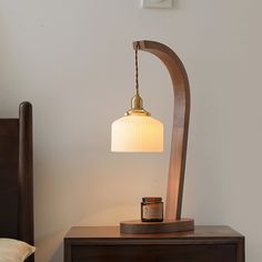 a table lamp sitting on top of a wooden dresser