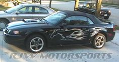 a black sports car with flames painted on it