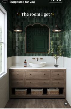 the bathroom is decorated in green and white with an interesting mirror above the sink, along with two wicker baskets on the floor