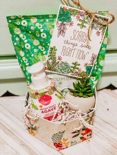 an open gift box with soap, lotion and other items in it sitting on a table