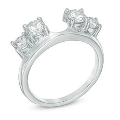 an engagement ring with three stones on the side and four diamonds on the top, set in