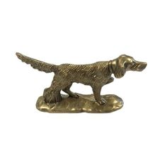 a bronze dog figurine on a white background