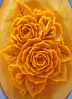 an arrangement of yellow flowers in a glass vase