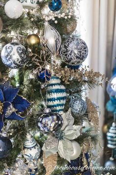 a christmas tree decorated with blue and white ornaments