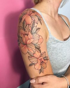 a woman with a flower tattoo on her arm