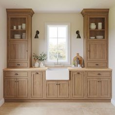 a kitchen with wooden cabinets and white walls