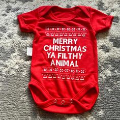 This Listing Is For A Baby Unisex Christmas Theme Onesie. It Is Red With Short Sleeves On The Front In White It Says, "Merry Christmas Ya Filthy Animal." It Is Size 3-6 Months. It Is New Without Tags. It Comes From A Non-Smoking Home. “** I Will Consider Reasonable Offers. But I Will Not Accept Offers For 50% Off Red Onesie For Playtime In Winter, Christmas Onsies Baby, Cute Cotton Onesie For Holidays, Red Onesie For Winter Holiday, Cute Fitted Red Onesie, Playful Red Christmas Tops, Cute Red Fitted Onesie, Cute Christmas Onesie, Cute Christmas Cotton Onesie