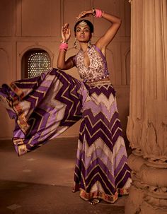 Make a style statement like a traditional diva in this alluring sharara set featuring geometrical print sharara coordinated with an intricately embroidered blouse with a stylised back design with heavy tassels and doris. Georgette Palazzo Set With Printed Motifs For Reception, Purple Palazzo Set With Zari Work For Navratri, Fitted Sharara With Printed Motifs For Reception, Purple Sharara For Transitional Season, Semi-stitched Georgette Lehenga With Printed Motifs, Designer Georgette Lehenga With Printed Motifs, Floor-length Georgette Lehenga With Printed Motifs, Purple Anarkali Palazzo Set With Cutdana, Semi-stitched Sharara With Pallu