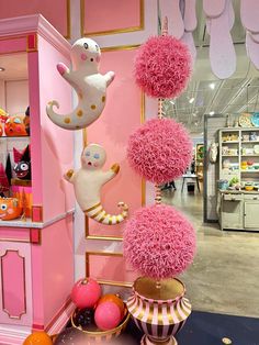 pink and gold decorations are on display in a store