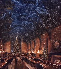 a large dining room filled with lots of tables covered in christmas decorations and lit candles