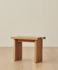 a wooden bench sitting on top of a hard wood floor