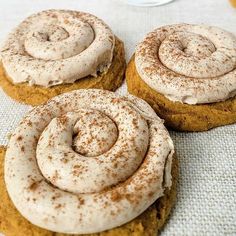 three cinnamon roll cookies sitting on top of a table