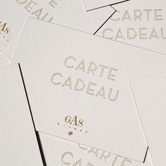 some white cards with gold lettering on them