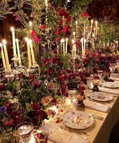 a long table is set with flowers and candles for an elegant dinner or party event