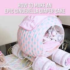 a pink and white diaper cake sitting on top of a table