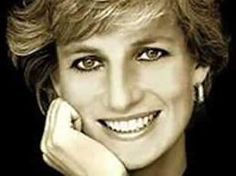 a black and white photo of a smiling woman with her hand on her chin, looking at the camera