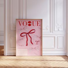 a pink poster with the word voque on it in front of a white wall