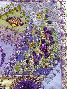 a close up of a piece of cloth with flowers and butterflies on it in purple