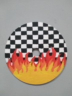 a black and white checkered disc with flames on it