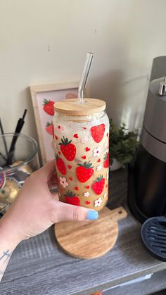 a person holding a strawberries drink in their hand