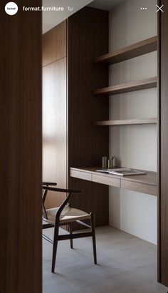 a chair sitting in front of a desk with shelves on both sides and a book shelf to the side