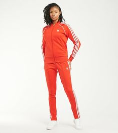 Regular fit (Jacket) Slim Fit (Pant) Full zip with ribbed collar Drawcord on elastic waist 50% cotton, 45% recycled polyester, 5% elastane interlock 3-Stripes track jacket and pant Side zip pockets Ribbed cuffs and hem Imported Product color: Red Product code: H18189/H34579 Spring Track Jacket With Three Stripes Branding, Adidas Athleisure Track Jacket With Side Stripes, Adidas Long Sleeve Tracksuit, Adidas Long Sleeve Tracksuit Sportswear, Adidas Sportswear Tracksuit, Adidas Sporty Long Sleeve Tracksuit, Sporty Adidas Tracksuit, Fitted Tracksuit With Ribbed Cuffs In Athleisure Style, Fitted Athleisure Tracksuit With Ribbed Cuffs