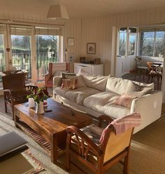 a living room filled with furniture and lots of windows