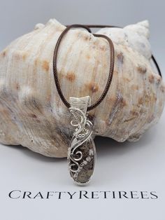 Embrace the natural beauty of Wild Horse Jasper with this stunning pendant, expertly wire-wrapped in sterling silver. Known for its earthy tones and unique patterns, Wild Horse Jasper is a gemstone that exudes warmth and grounding energy. This pendant showcases the stone's distinctive blend of brown, cream, and gray hues, making it a perfect accessory for those who love nature-inspired jewelry. Jasper's Unique Qualities: Wild Horse Jasper is celebrated for its grounding properties and connection Sterling Silver Brown Wire Wrapped Jewelry, Wire Wrapped Ocean Jasper Pendant Jewelry, Nature-inspired Sterling Silver Wire Wrapped Necklaces, Nature-inspired Wire Wrapped Sterling Silver Necklaces, Nature-inspired Sterling Silver Wire Wrapped Jewelry, Grounding Energy, Earthy Jewelry, Rock Jewelry, Wrap Jewelry