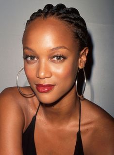 a close up of a person wearing large hoop earrings