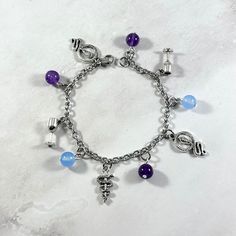 a bracelet with charms and beads on it