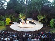 an aerial view of a stage with people sitting on it