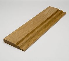 a piece of wood sitting on top of a white table