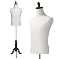 two white mannequins are standing next to each other on wooden stands, one is black and the other is white