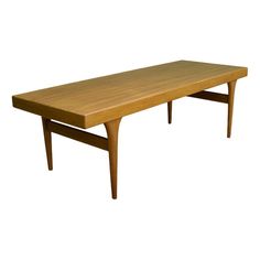 a wooden table sitting on top of a white background