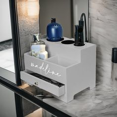 a bathroom vanity with soap, toothbrushes and other personal care items on it