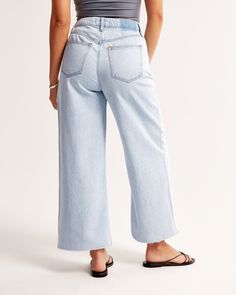 Our Curve Love high rise cropped wide leg jeans in a light wash with a raw-cut hem. This fit features a 10.5” high rise, is relaxed at the waist and hips, and eases into a wide, full-length leg shape with a cropped length. Our Curve Love styles add an additional 2” at the hip and thigh to allow room for your curves and eliminate waist gap. This jean is made from our super light drapey denim fabric, which features a super soft lightweight rigid denim. Female Features, Cropped Wide Leg Jeans, Women's Bottoms, Jeans Light Wash, Denim Collection, Extra Room, Jeans Light, Pocket Bag, Denim Fabric