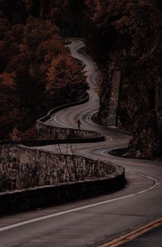 a person standing on the side of a winding road