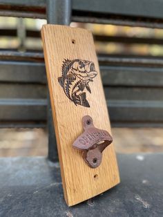 a wooden sign with a fish on it