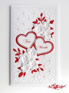 a card with two hearts and flowers on the front, in red and white colors