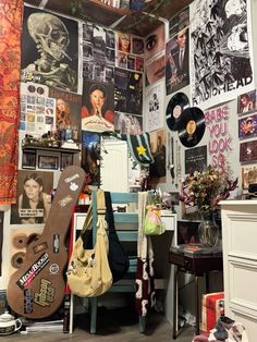 a room filled with lots of posters and guitars