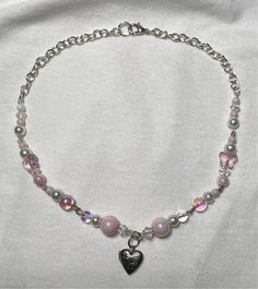 handmade by me :) made with various glass beads, empty heart locket and a lobster claw clasp the necklace measures 15 inches long but can be adjusted for a smaller fit  treat gently as costume jewelry  let me know if you have any questions Locket Beaded Necklace, Pink Beaded Heart Pendant Necklace, Pink Adjustable Heart Beaded Necklace, Pink Heart Pendant Beaded Necklace For Valentine's Day, Handmade Pink Heart Crystal Necklaces, Pink Heart Pendant Charm Necklace With Lobster Clasp, Pink Heart-shaped Charm Necklaces With Lobster Clasp, Pink Heart-shaped Charm Necklace With Lobster Clasp, Cute Pink Beaded Charm Necklaces