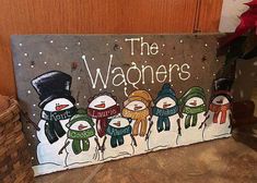 a sign that says the wagons with snowmen in scarves and hats on it