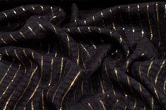 a black and gold striped fabric with metallic foil on it's edges, close up