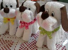 three stuffed dogs sitting on top of a table